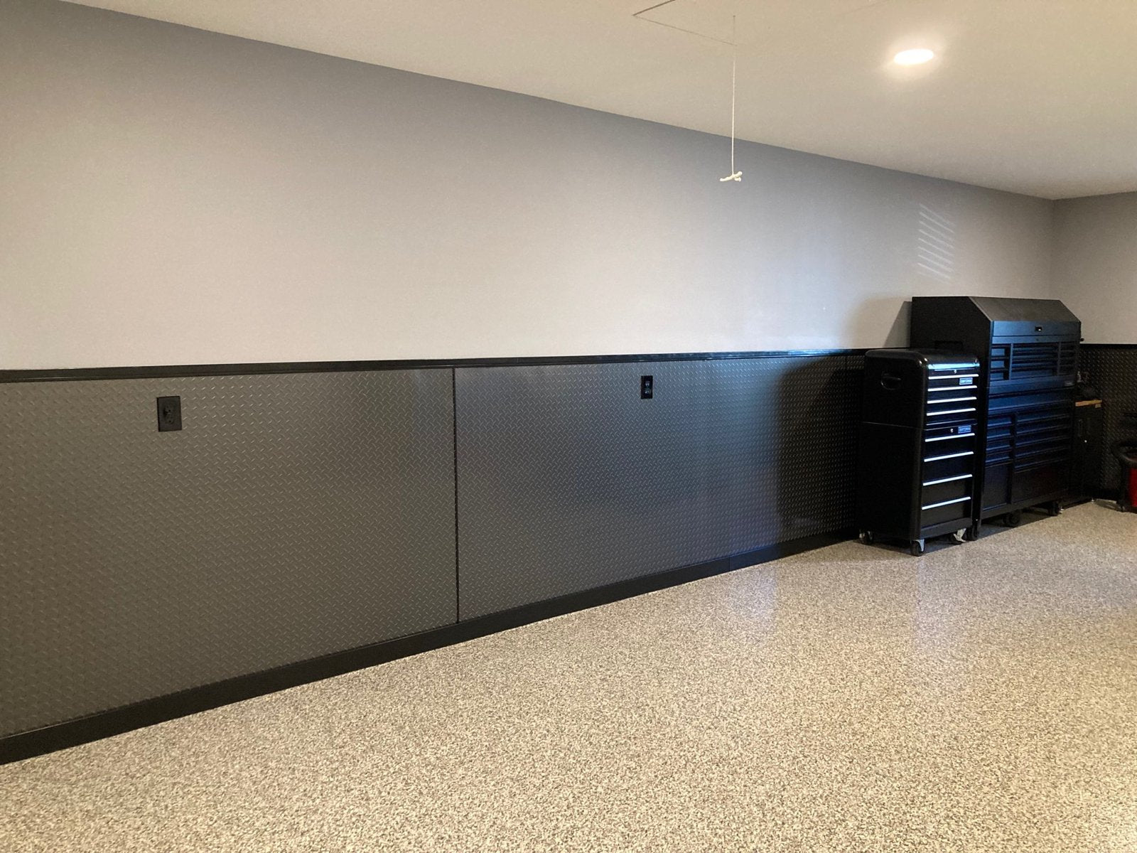 Gunmetal gray aluminum diamond plate sheets on garage walls
