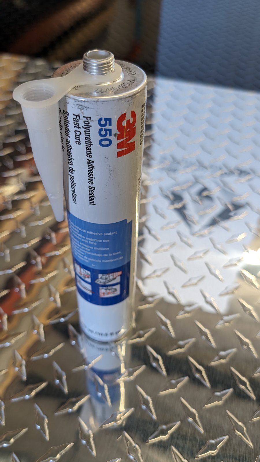 Construction adhesive for attaching embossed diamond plate to garage walls